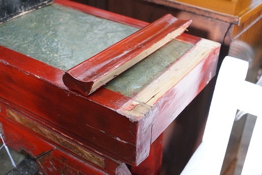 A Chinese carved scarlet and gilt painted altar table with faux stone top, length 198cm, depth 41cm, height 98cm